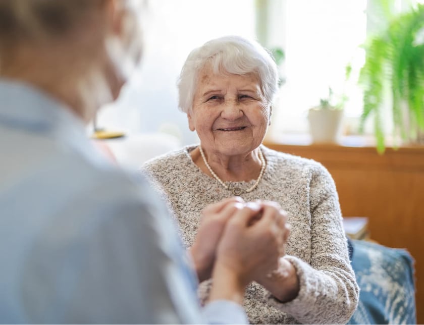 caregiver_providing_emotional_support_to_elderly_woman