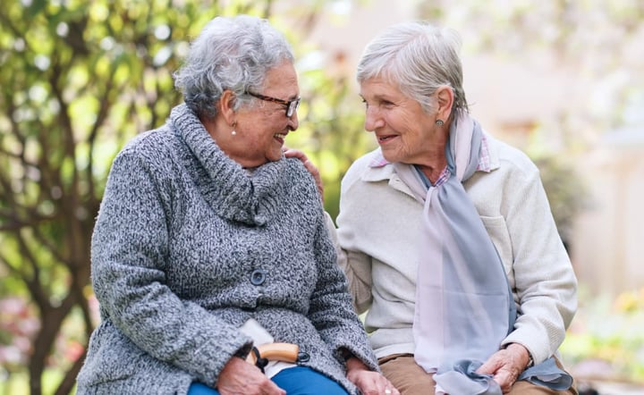 two_elderly_women_sitting_on_a_bench